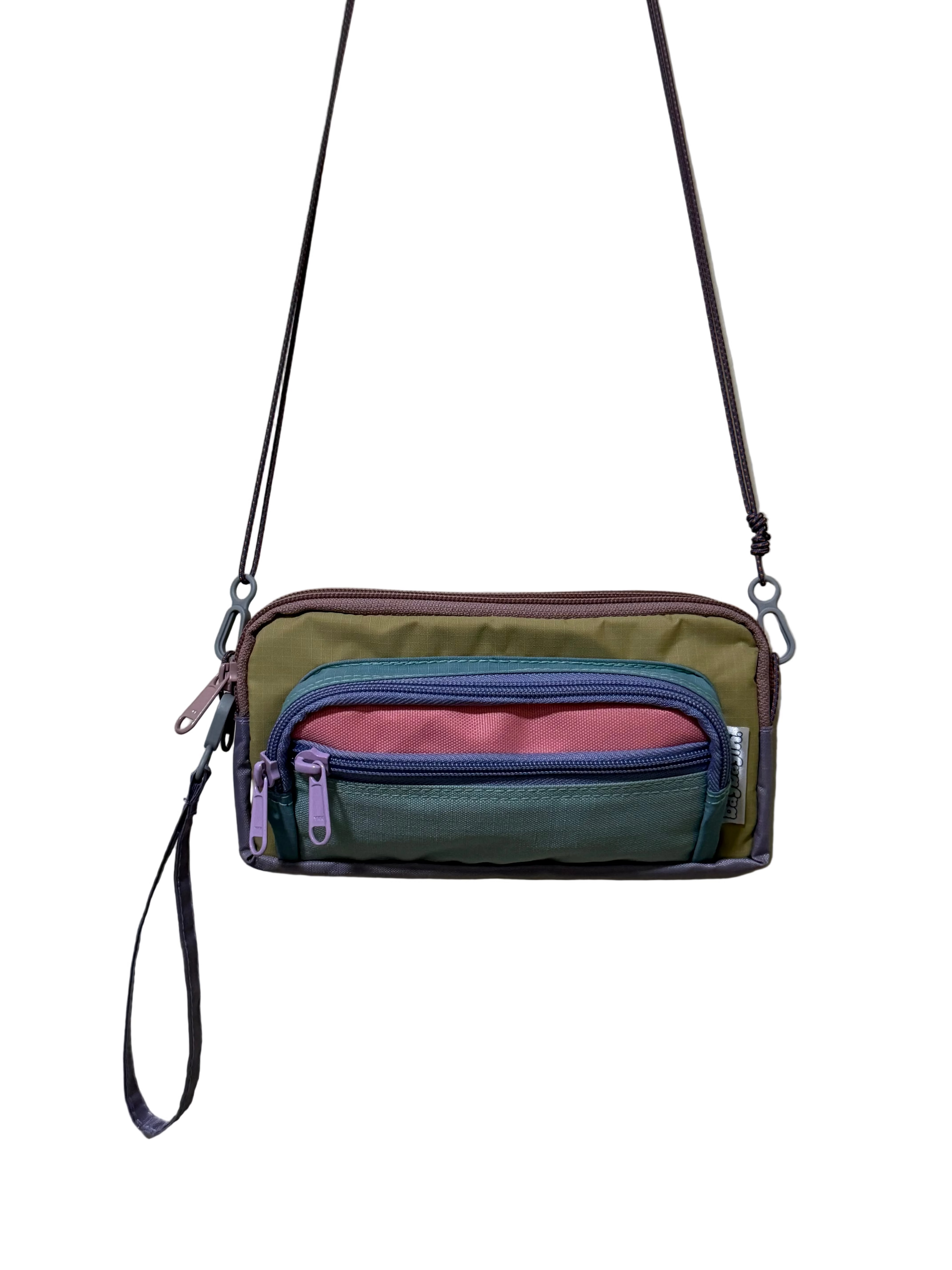 Multicolored crossbody bag with multiple compartments on a light gray background