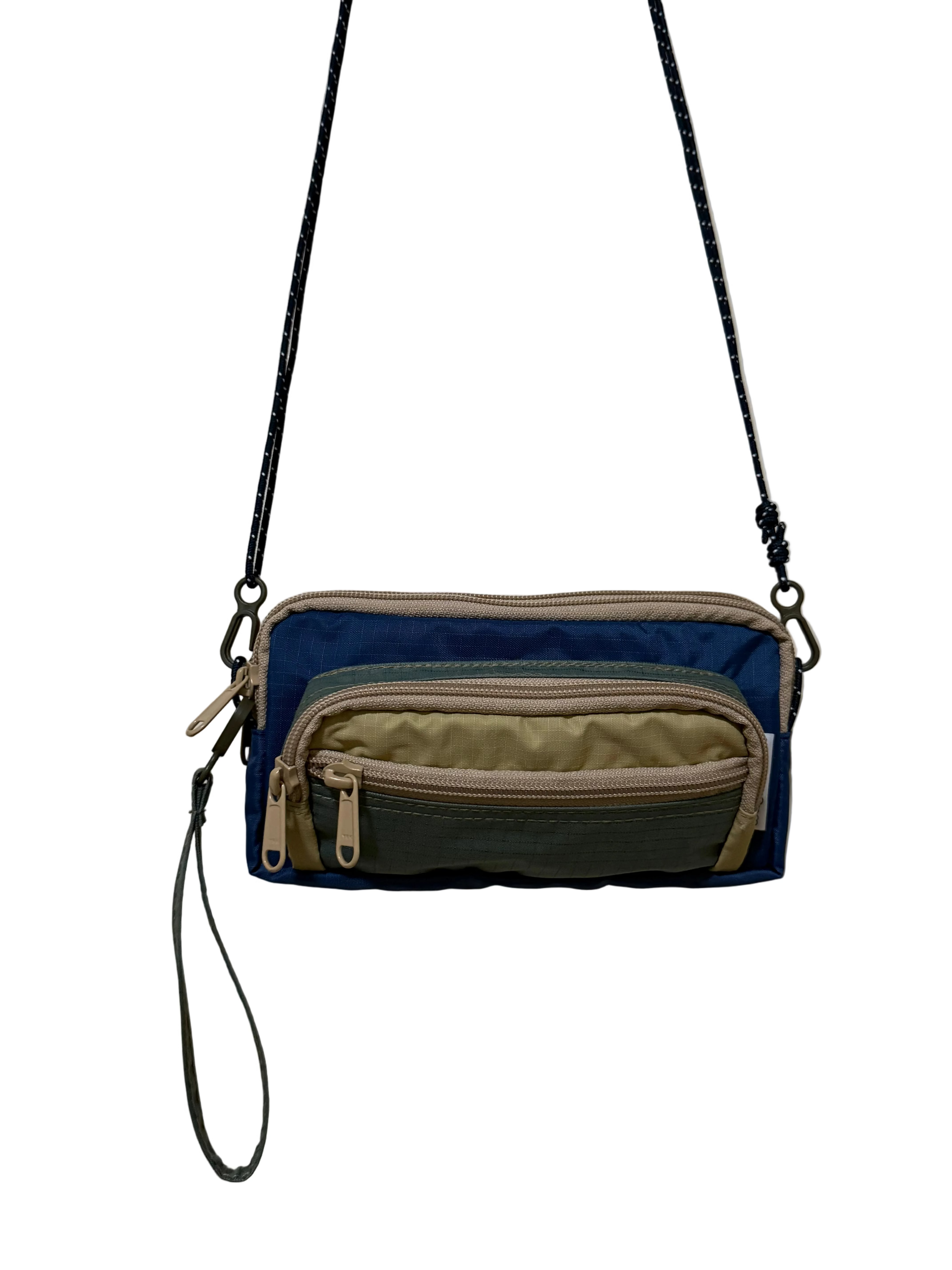 Multicolored crossbody bag with zippers on a plain background