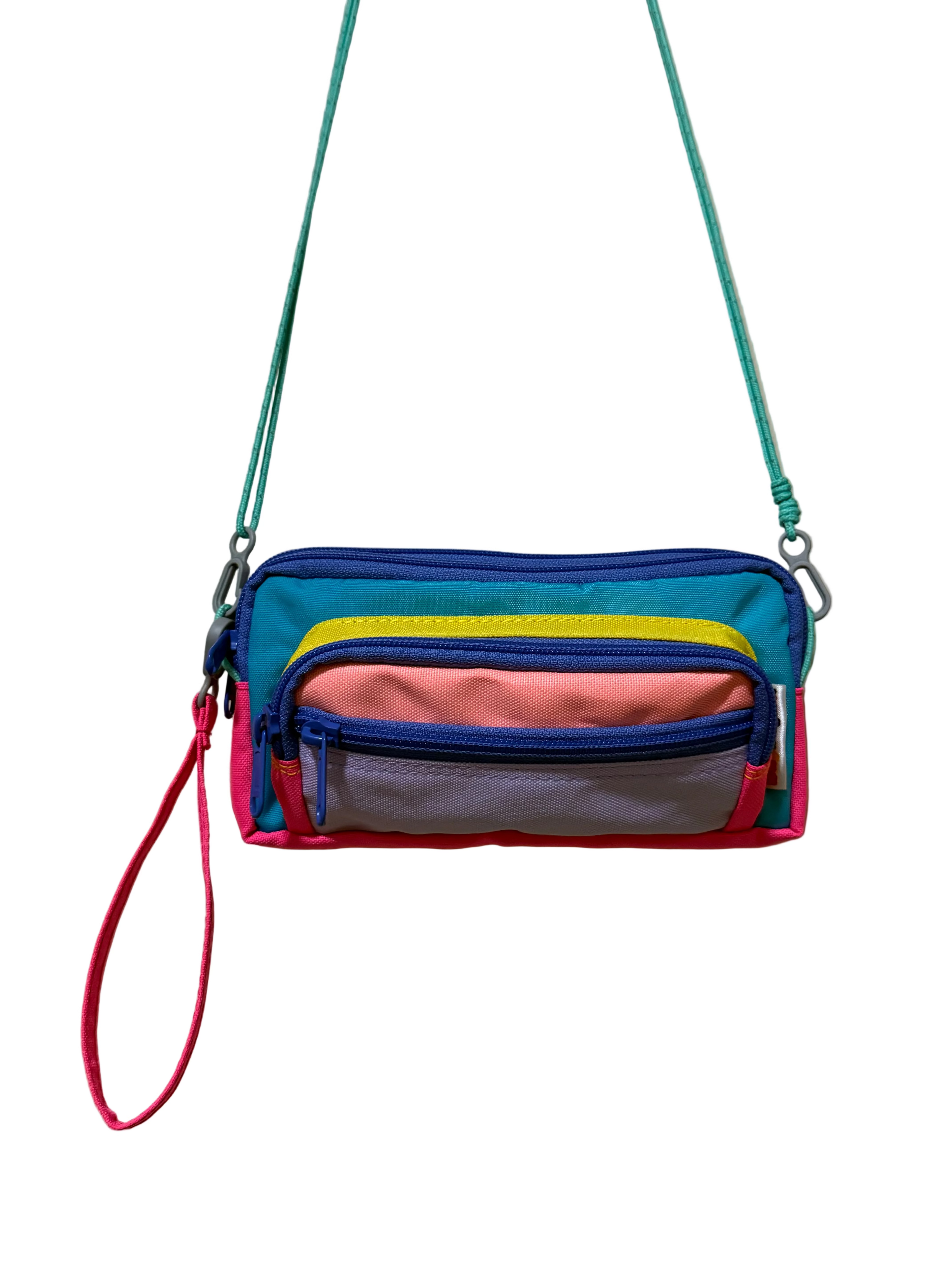 Multicolored crossbody bag with a strap on a beige background