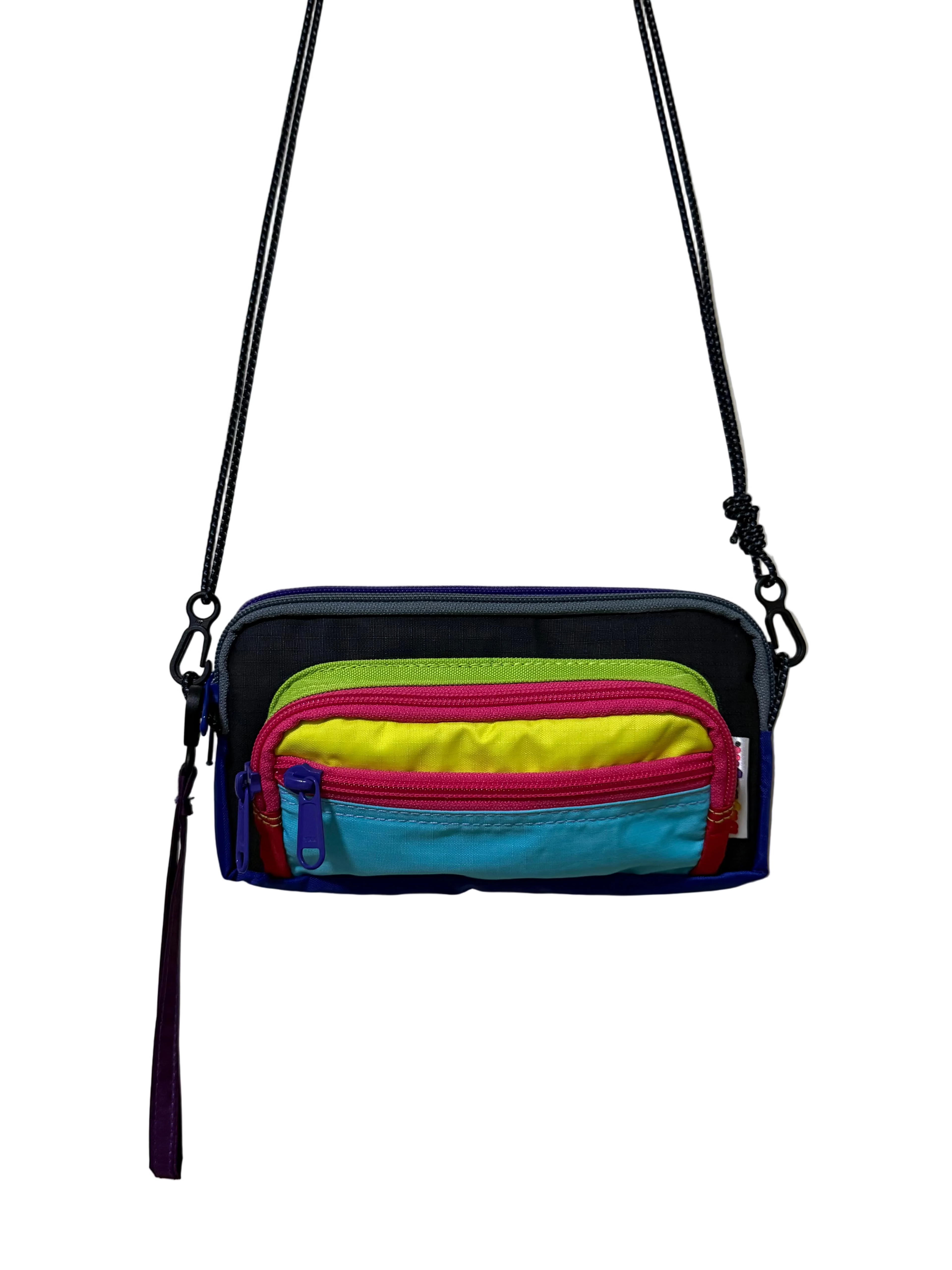 Multicolored pouch with zippers on a plain background