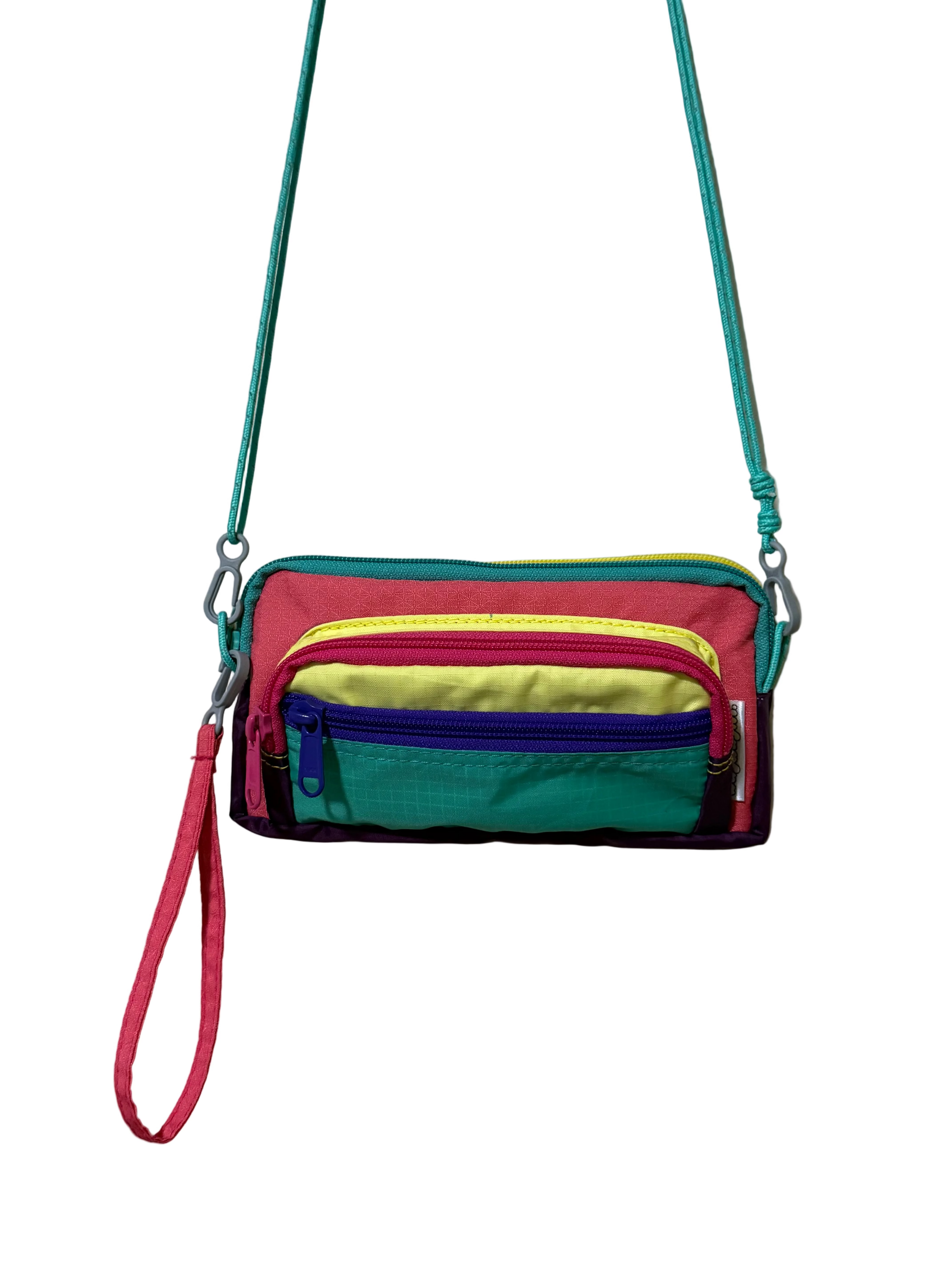 Multicolored crossbody bag with a strap on a light gray background