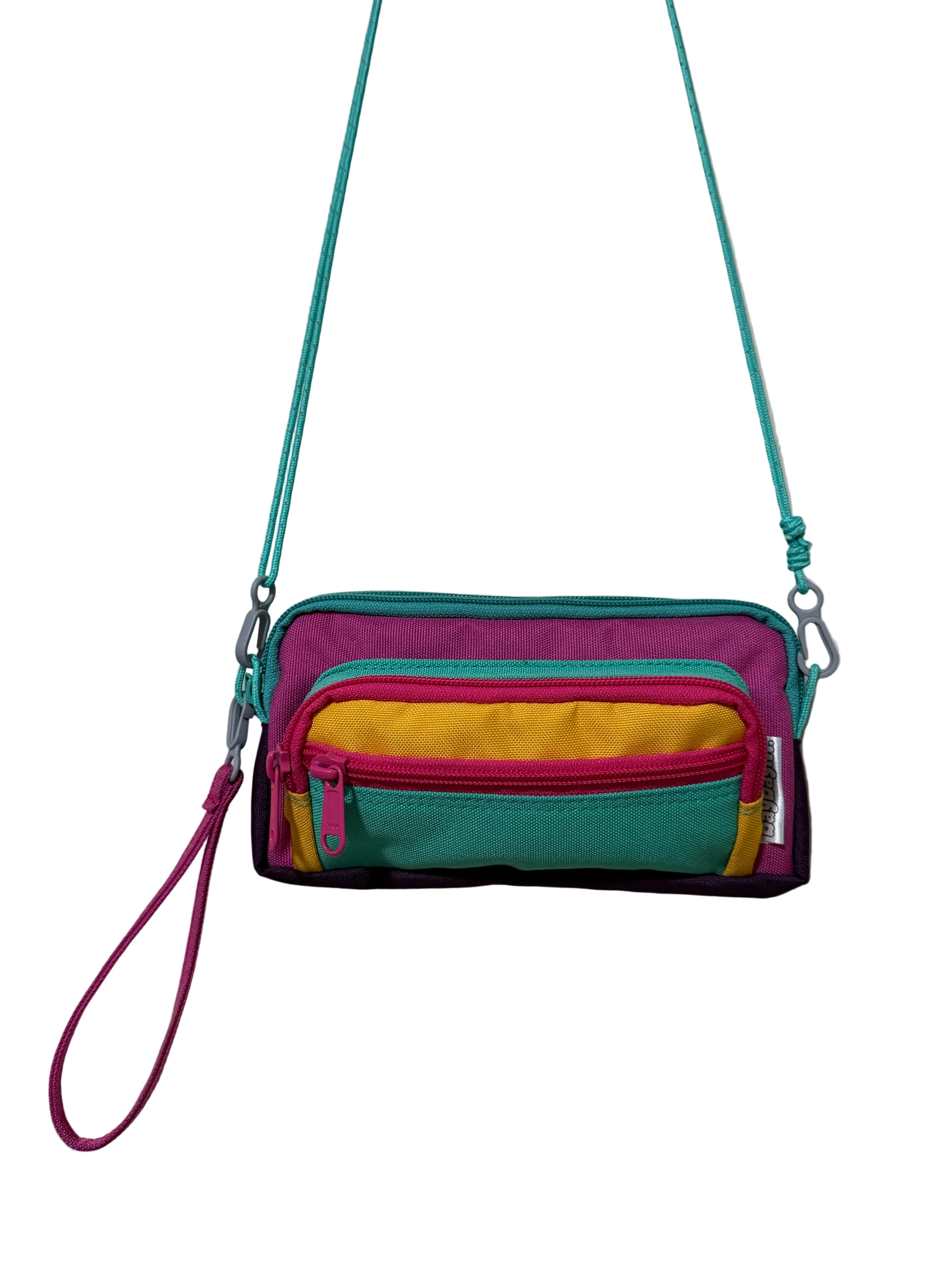 Colorful crossbody bag with a strap on a light gray background