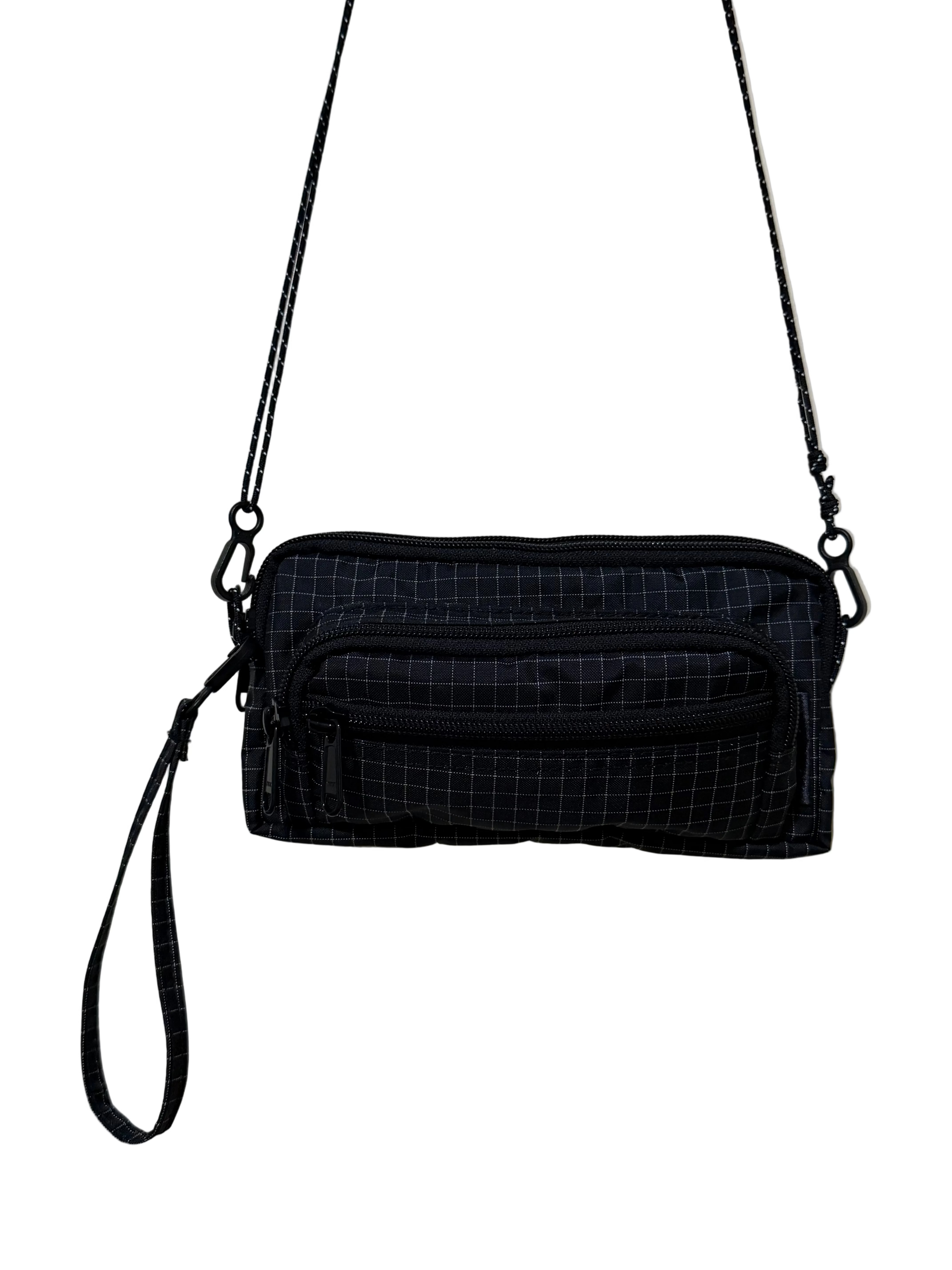 Black grid-patterned crossbody bag on a white background