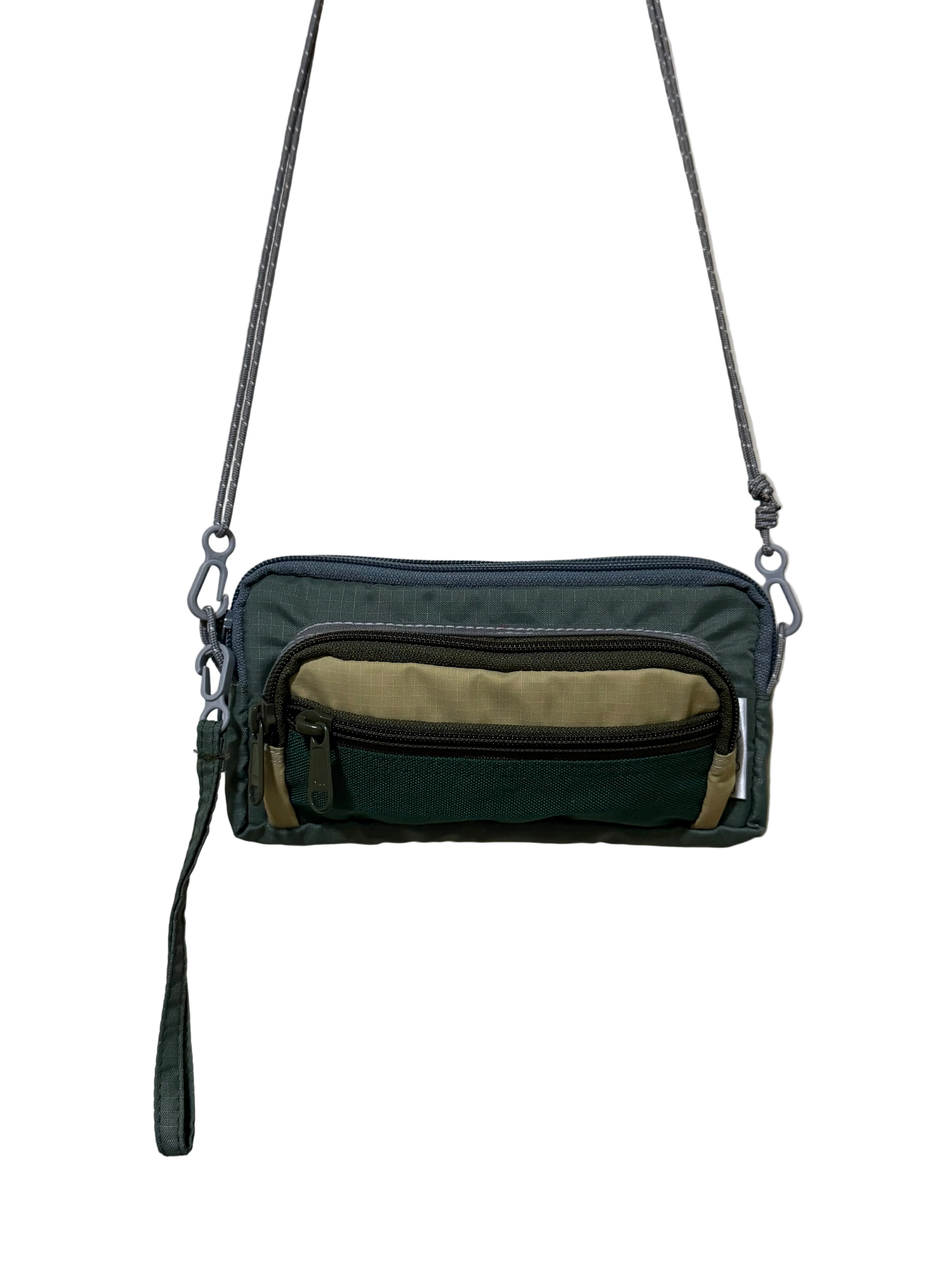 Multicolored crossbody bag with zippers on a beige background